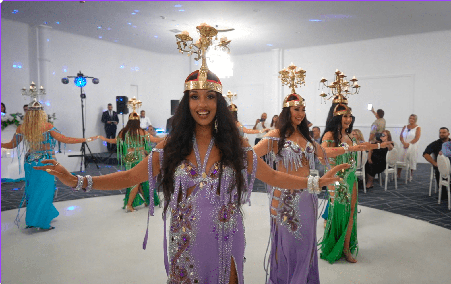 women dancing a traditional Egyptian dance balancing candelabras on their heads